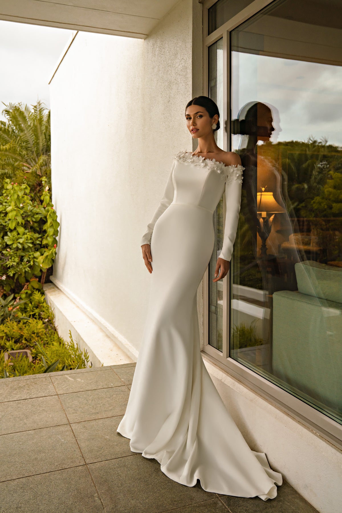 Ivory mermaid wedding dress with long sleeves, a floral neckline, fitted bodice, and sweeping train