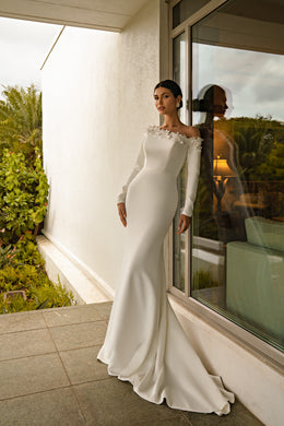 Ivory mermaid wedding dress with long sleeves, a floral neckline, fitted bodice, and sweeping train