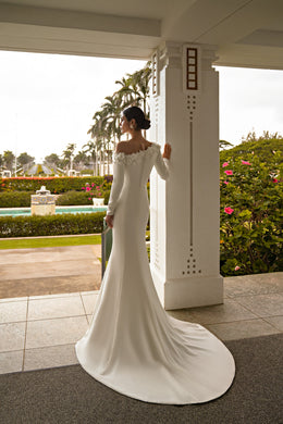 Ivory wedding dress with an off-shoulder floral neckline, long sleeves, mermaid shape, and wide train