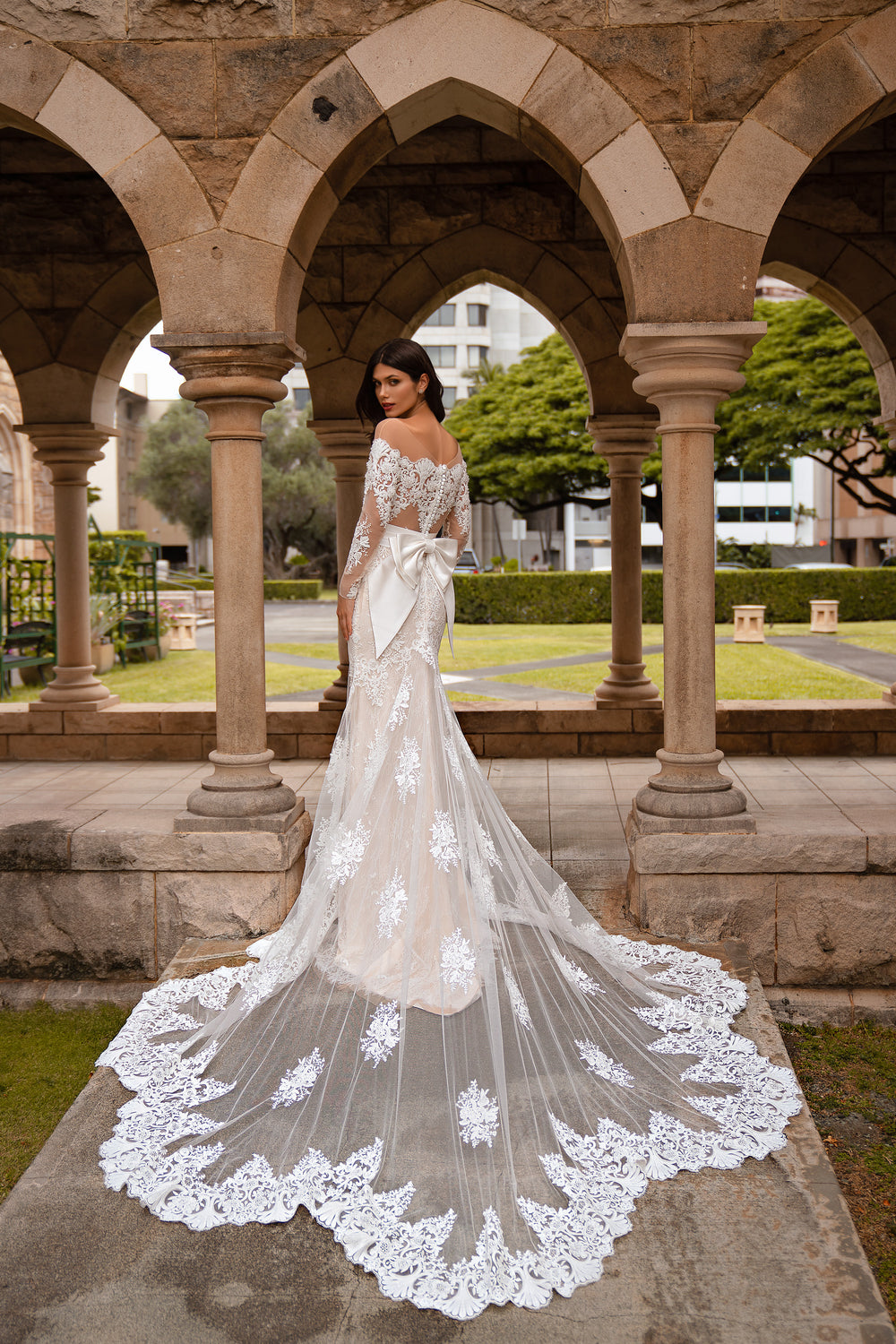 Elegant Mermaid Silhouette Wedding Dress with Train, Long Sleeves, Sequins, Guipure, Crystals, and Detachable Belt Bow.