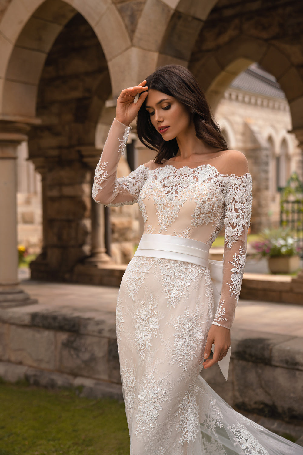 Elegant Mermaid Silhouette Wedding Dress with Train, Long Sleeves, Sequins, Guipure, Crystals, and Detachable Belt Bow.