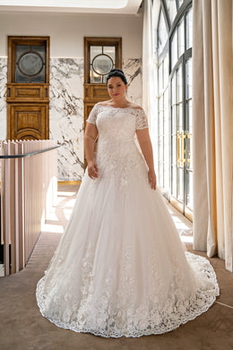 Ivory ball gown wedding dress with an off-the-shoulder lace neckline, short sleeves, floral appliqués, and a sweeping train