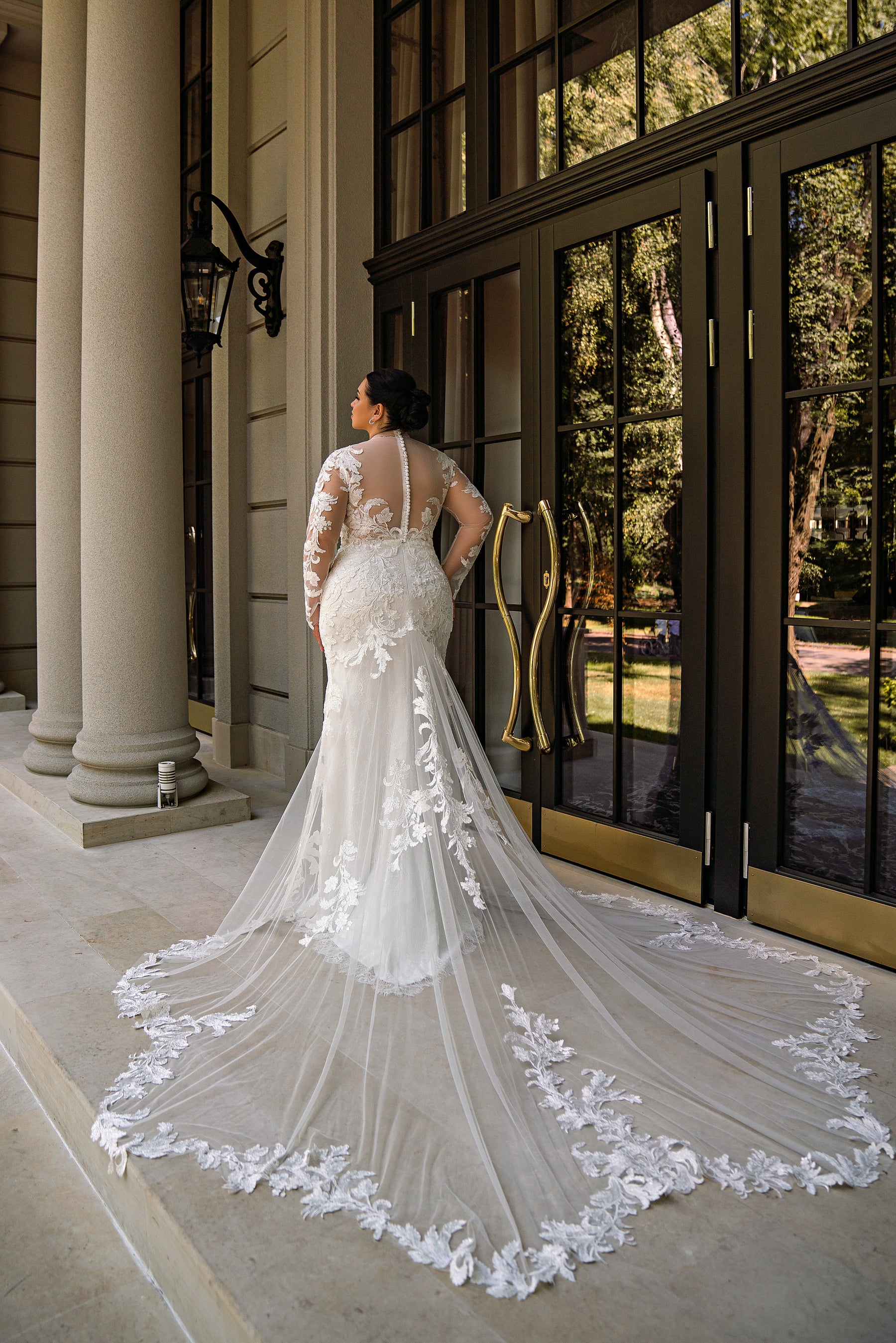 Lace-covered back and dramatic floral-edged train on an ivory mermaid wedding dress