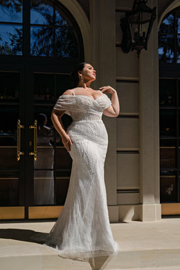 Fitted mermaid wedding dress in ivory with a sparkling off-shoulder neckline and floor-length train