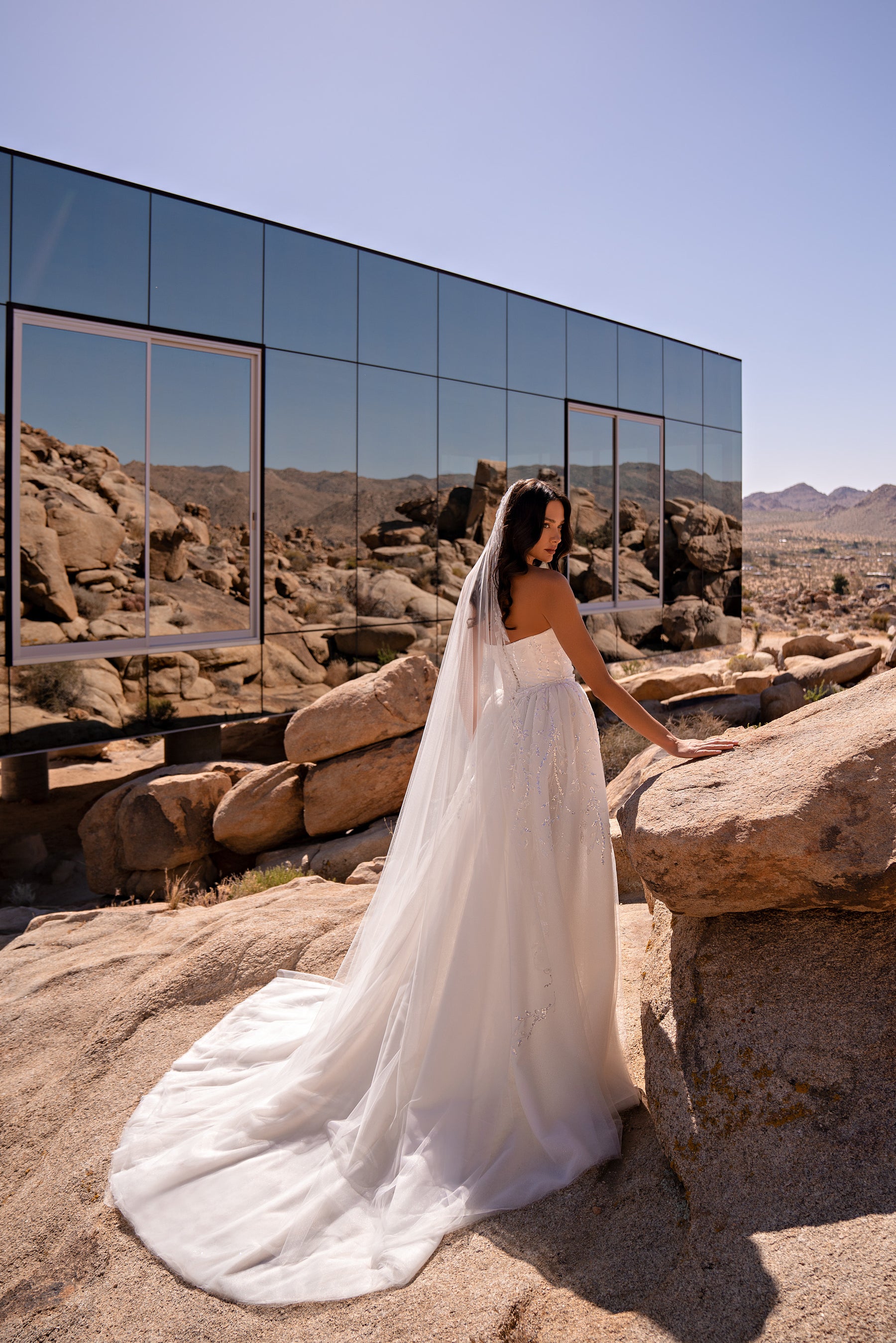 Sparkling white wedding dress with a fitted silhouette and long flowing train