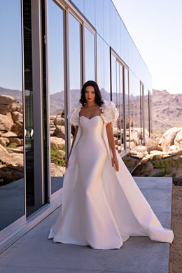 Ivory mermaid wedding dress with a sweetheart neckline, 3D floral puff sleeves, and a detachable cape train