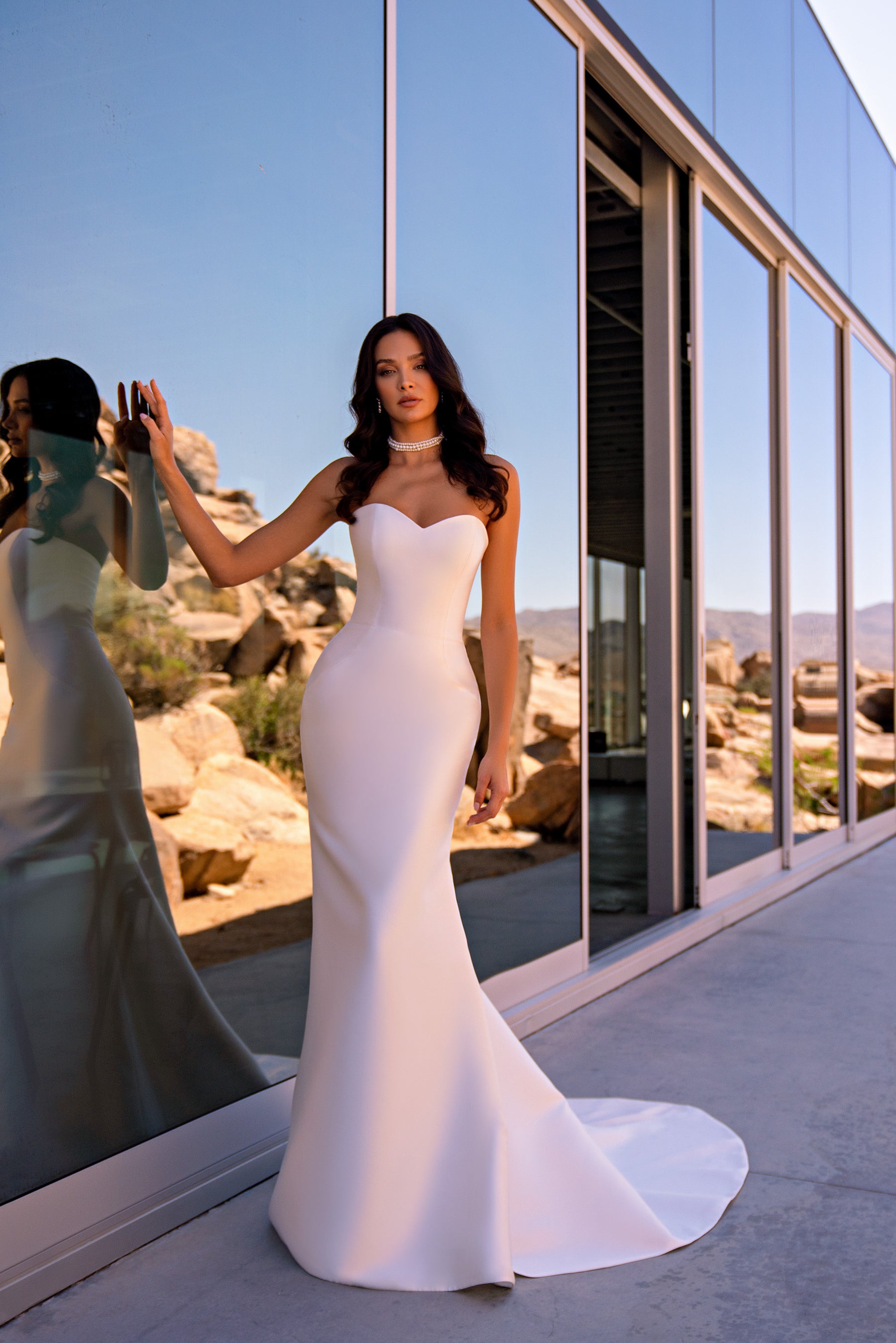 Strapless ivory mermaid wedding dress with a sweetheart neckline and a softly flared long train