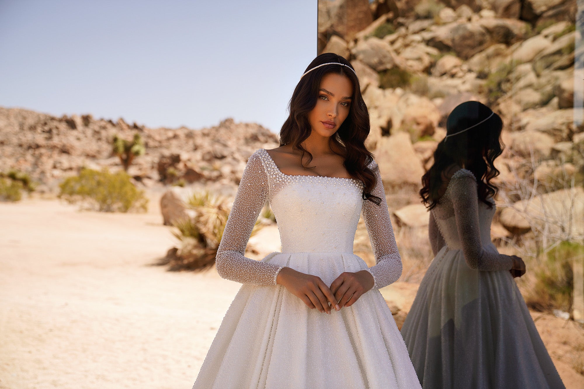 Square-neck ivory wedding dress with sparkling sheer long sleeves, a fitted bodice, and a full skirt