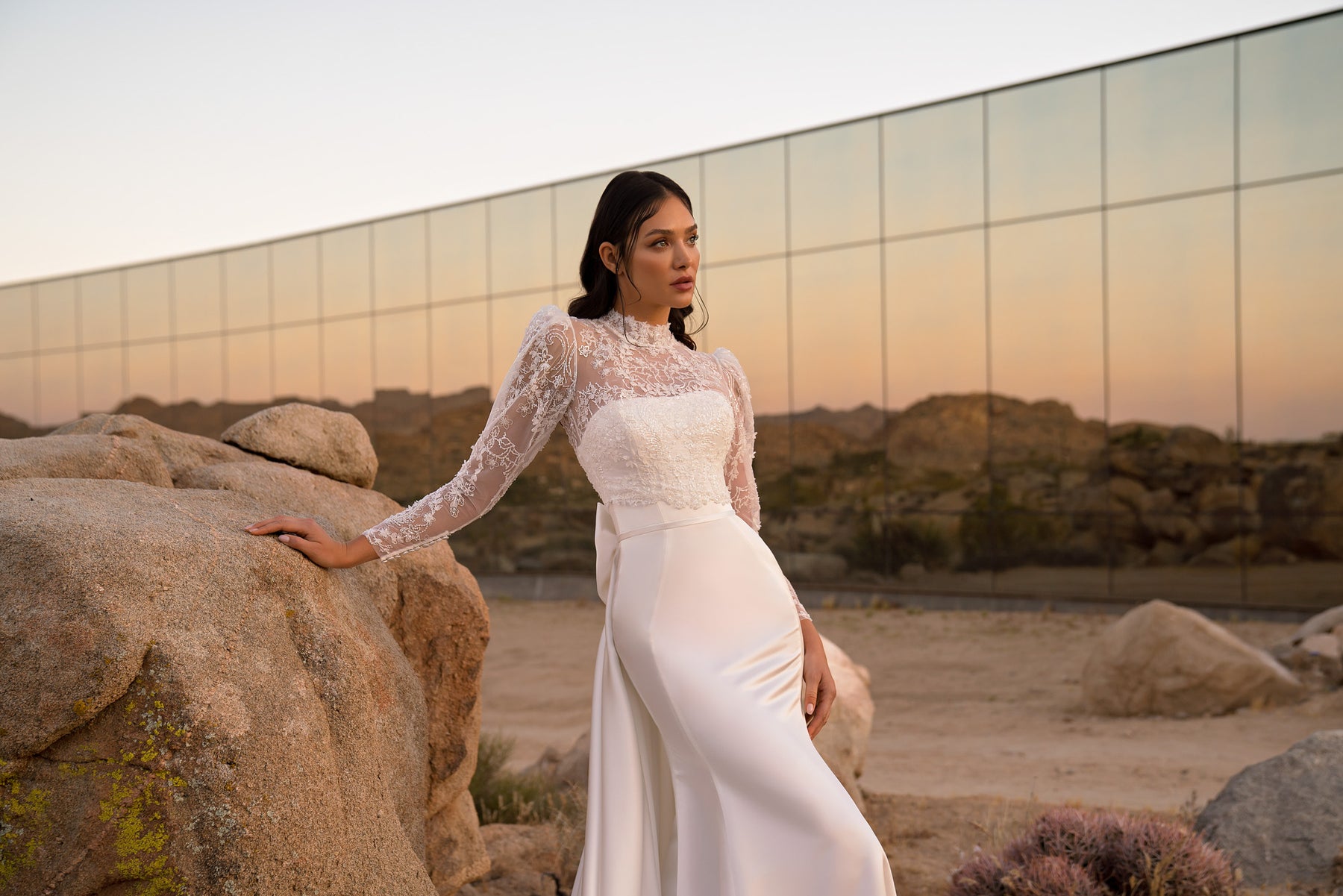 Fitted ivory wedding dress with a lace long-sleeve bolero and high neckline