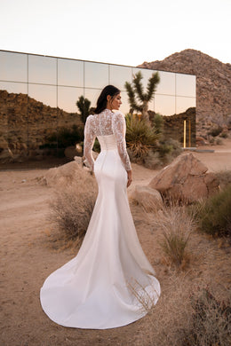 Ivory mermaid wedding dress with long floral lace sleeves, fitted back, and a sweeping train