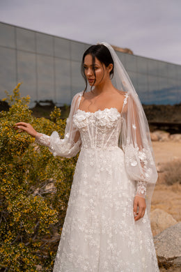 Square-neck ivory wedding dress with a floral-appliqué bodice and sheer bishop sleeves
