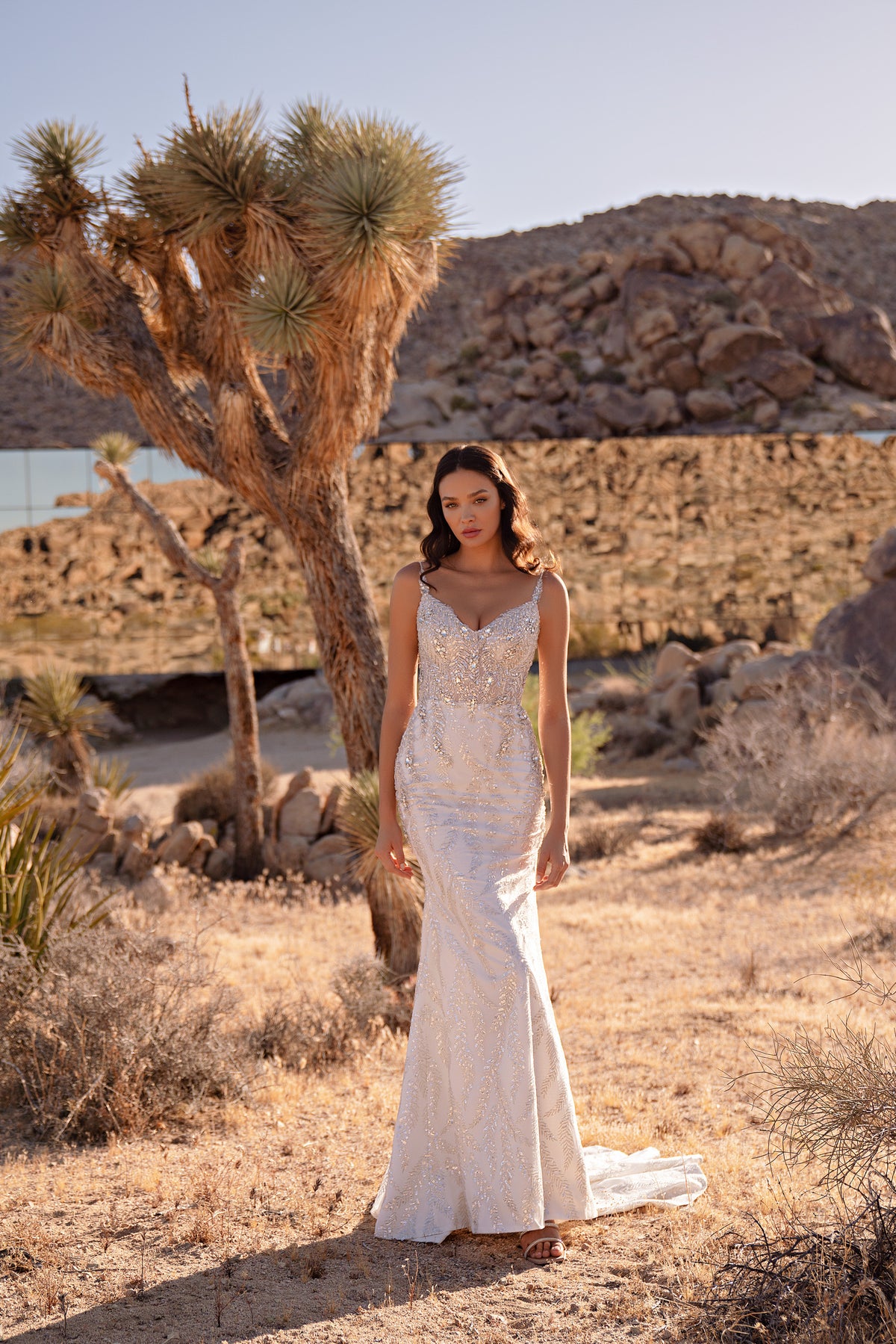 Ivory mermaid wedding dress with a beaded sweetheart bodice, fitted skirt, and trailing hem