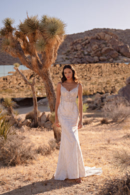 Ivory mermaid wedding dress with a beaded sweetheart bodice, fitted skirt, and trailing hem