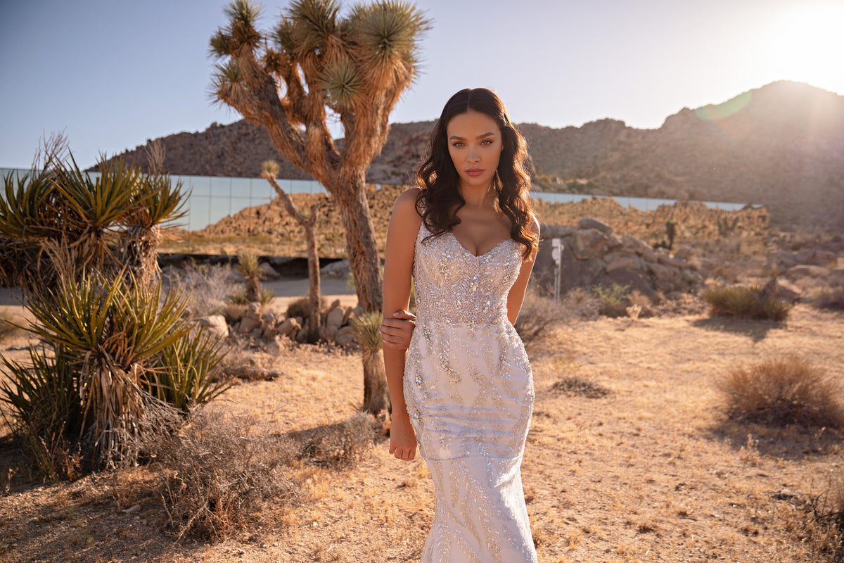 Beaded ivory wedding dress with a sweetheart neckline, slim straps, and fitted mermaid silhouette