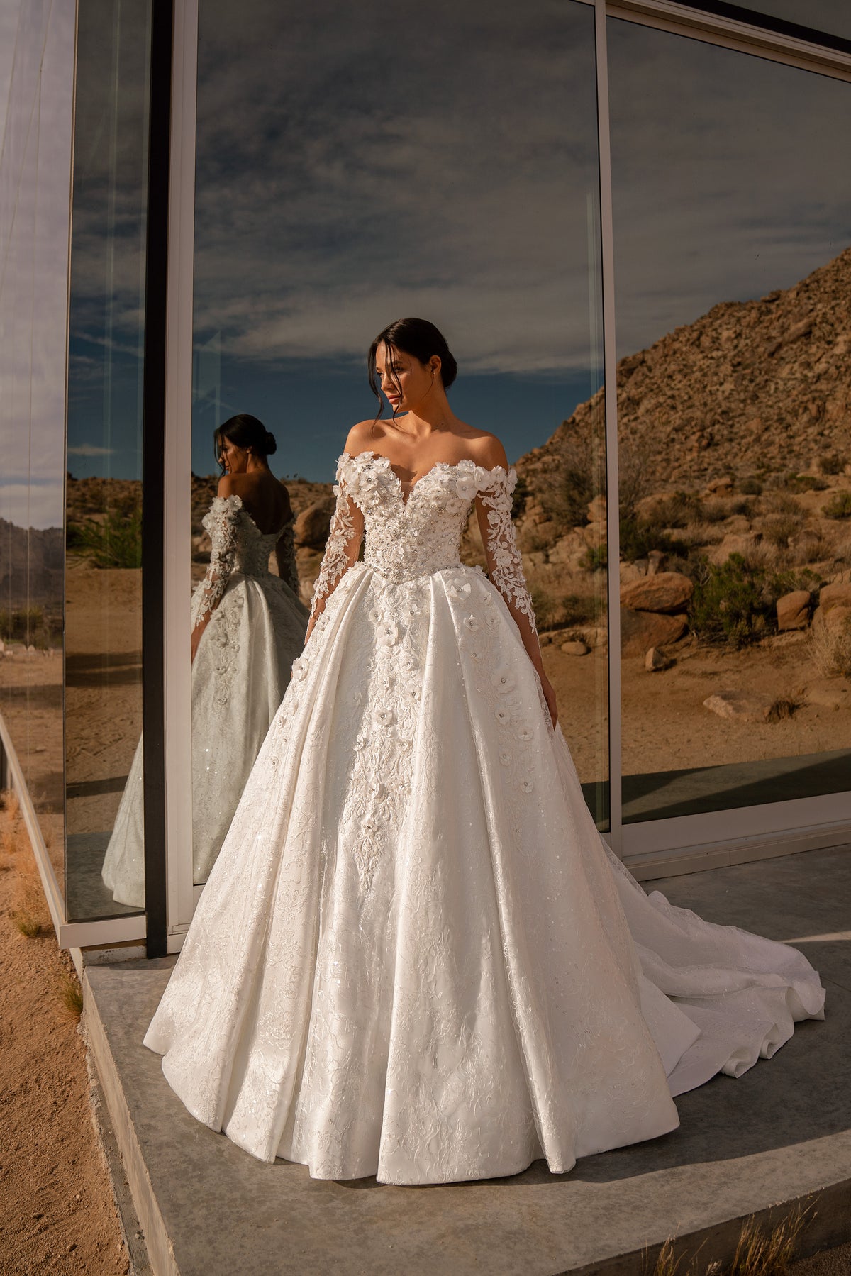 Ivory ball gown wedding dress with a sweetheart neckline, off-the-shoulder lace sleeves, and long train