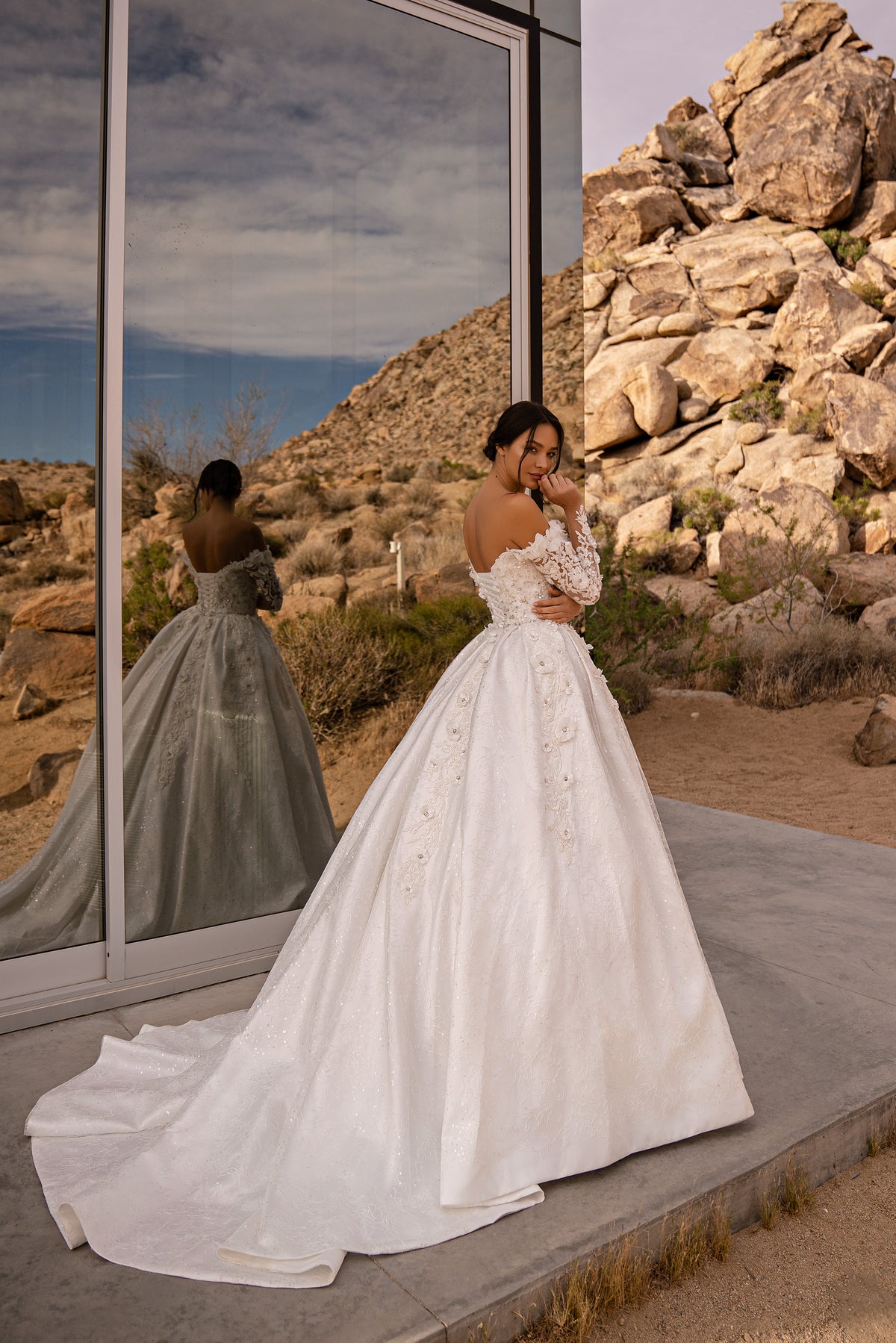 Ivory wedding dress with an off-the-shoulder lace back, full ball gown skirt, and sweeping train