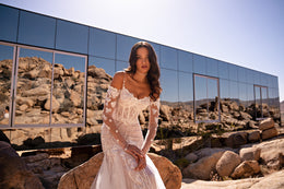 Ivory mermaid wedding dress with sheer lace sleeves, floral appliqués, and a sweetheart neckline