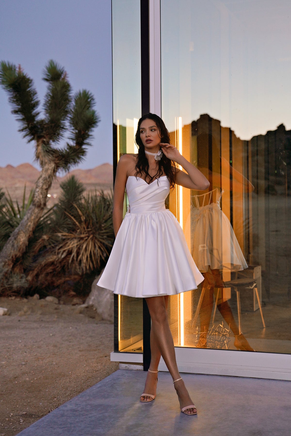 Ivory strapless wedding dress with a draped bodice and short, full satin skirt