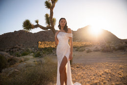Ivory sparkly wedding dress featuring an off-the-shoulder neckline, fitted bodice, and thigh-high slit
