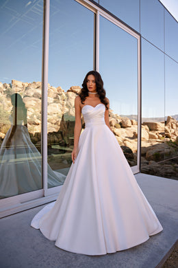 White A-line wedding dress with a strapless draped sweetheart bodice and full flowing skirt