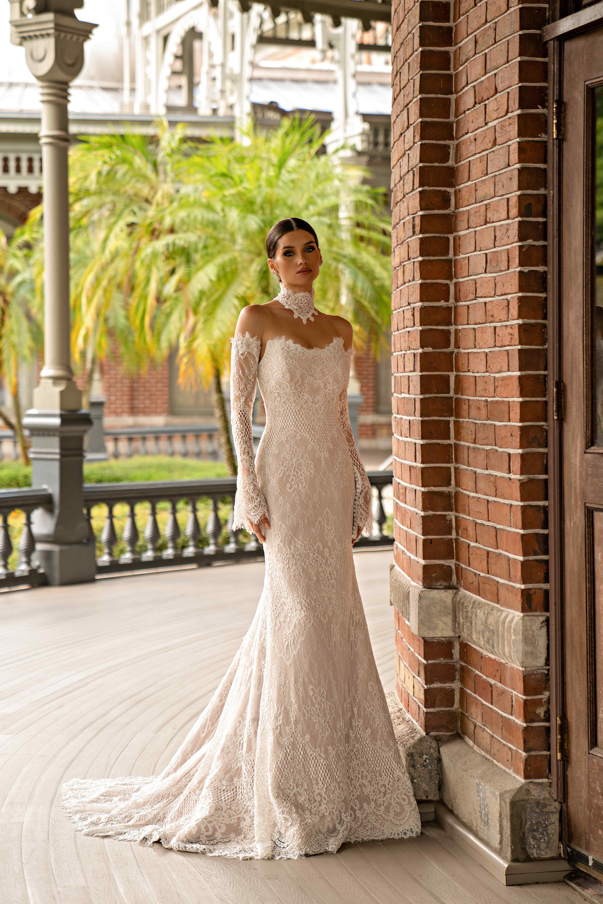Ivory lace sheath wedding dress with long sleeves, a fitted silhouette, and scalloped train