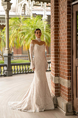 Ivory lace sheath wedding dress with long sleeves, a fitted silhouette, and scalloped train