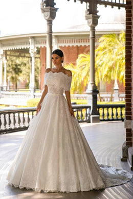 Ivory A-line wedding dress with an off-shoulder lace neckline, short sleeves, and a full flowing skirt