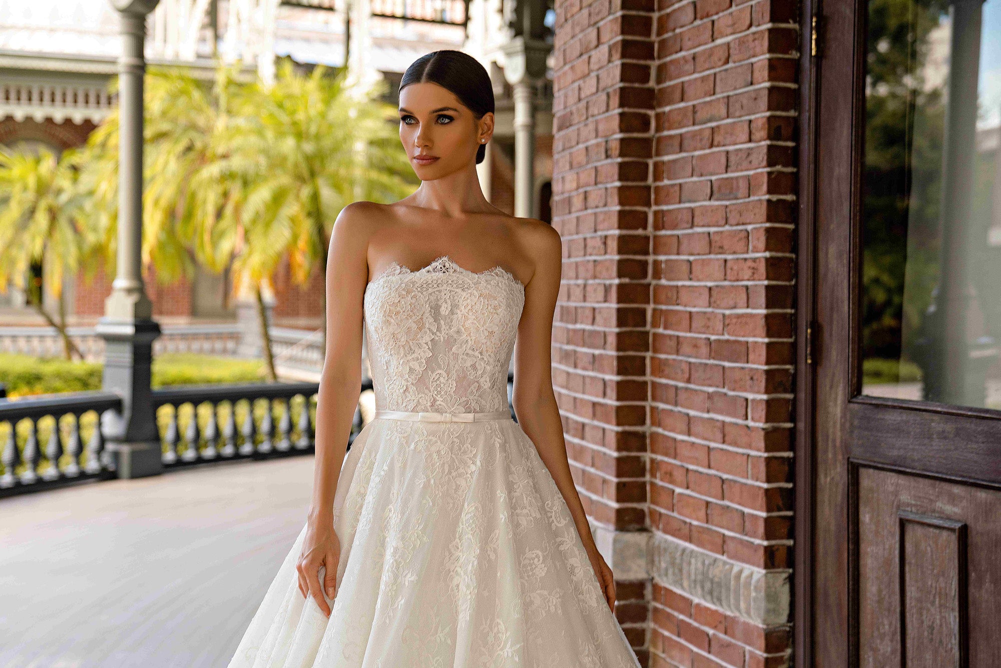 Close-up of an ivory strapless wedding dress with a sweetheart neckline and lace-covered bodice