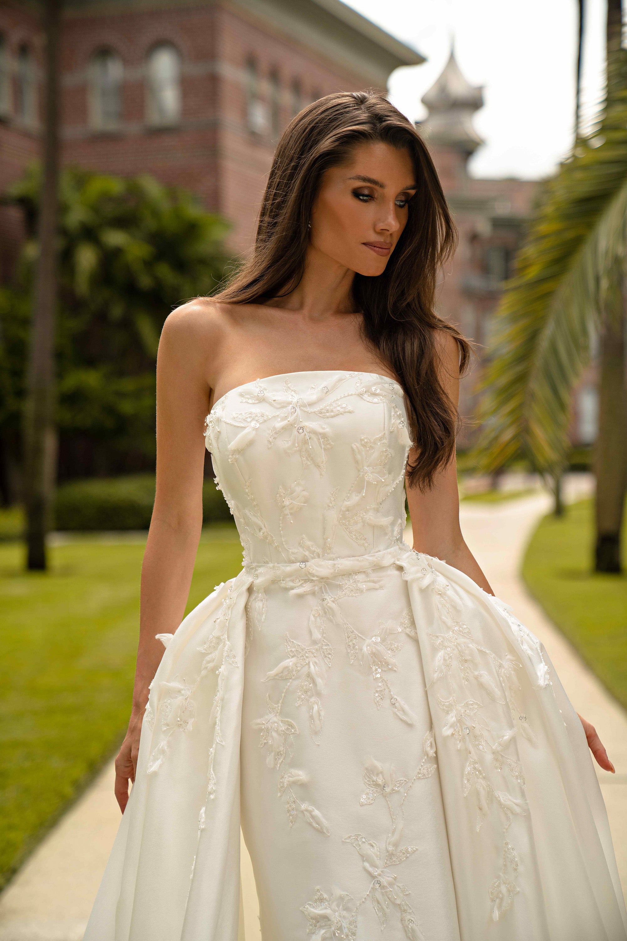 Close-up of an ivory strapless wedding dress bodice with a straight neckline and floral appliqués