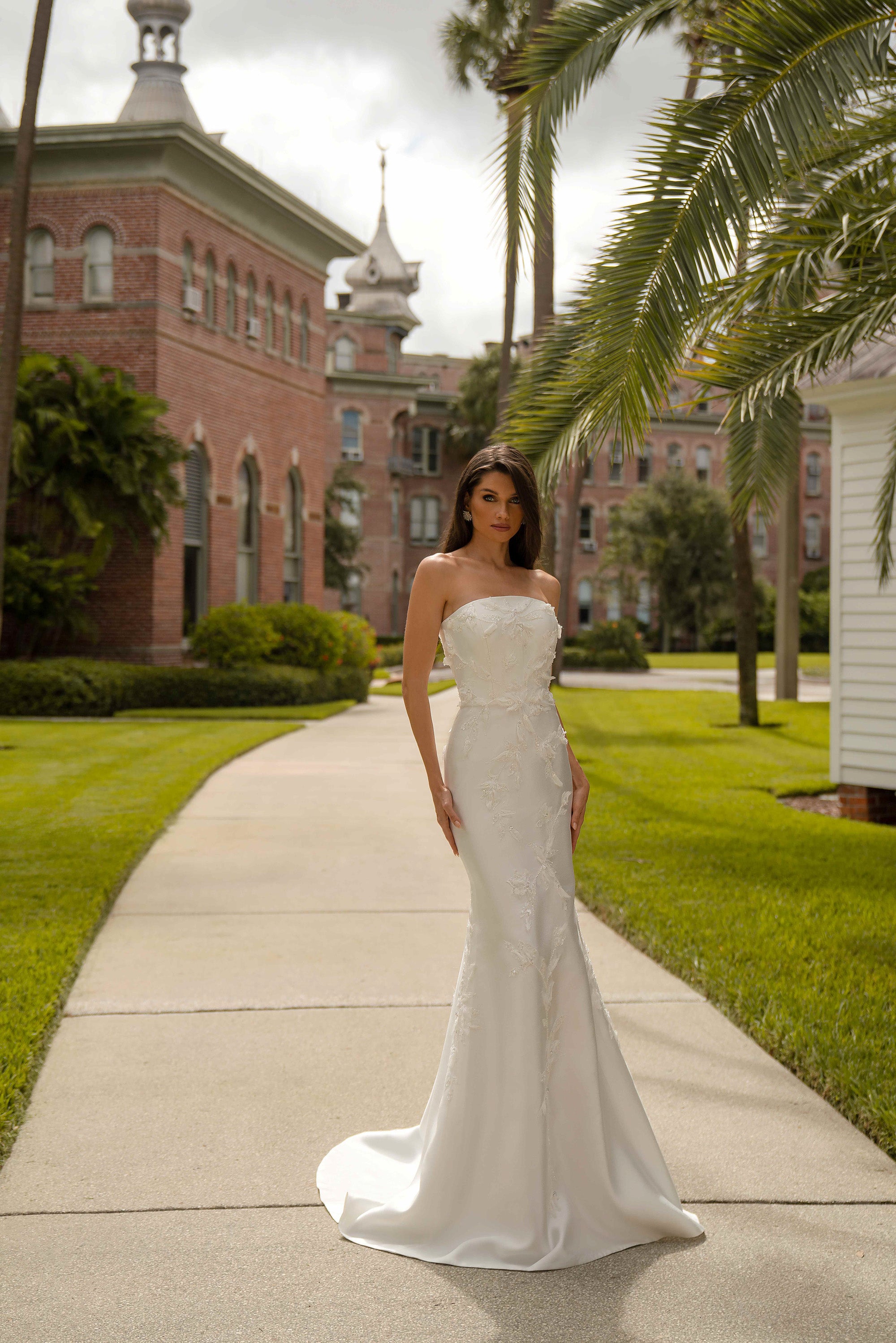 Ivory strapless sheath wedding dress with a sweetheart neckline and floral lace embellishment