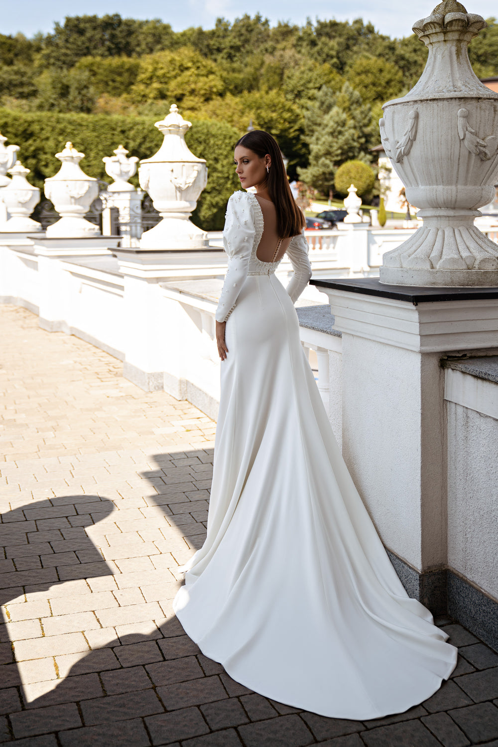 Elegant Minimalist Wedding Dress with Godet Silhouette, Long Sleeves, Train, and Crystal & Pearl Embroidery