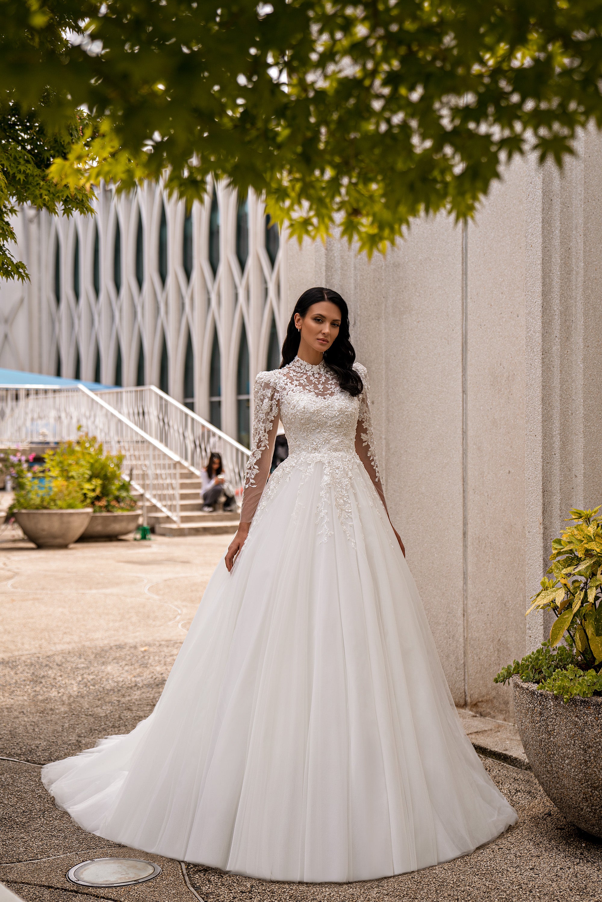 Ivory A-line wedding dress with a high lace neckline, long sleeves, and a full flowing skirt