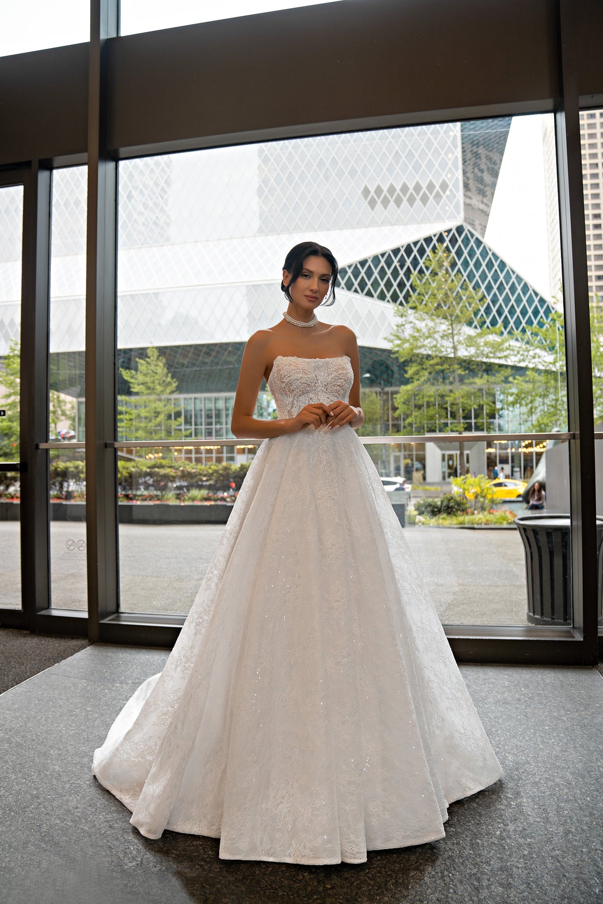 Strapless ivory wedding dress with a beaded lace bodice and full ball gown skirt
