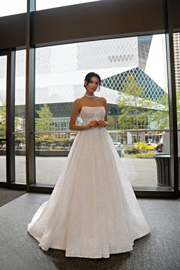 Strapless ivory wedding dress with a beaded lace bodice and full ball gown skirt