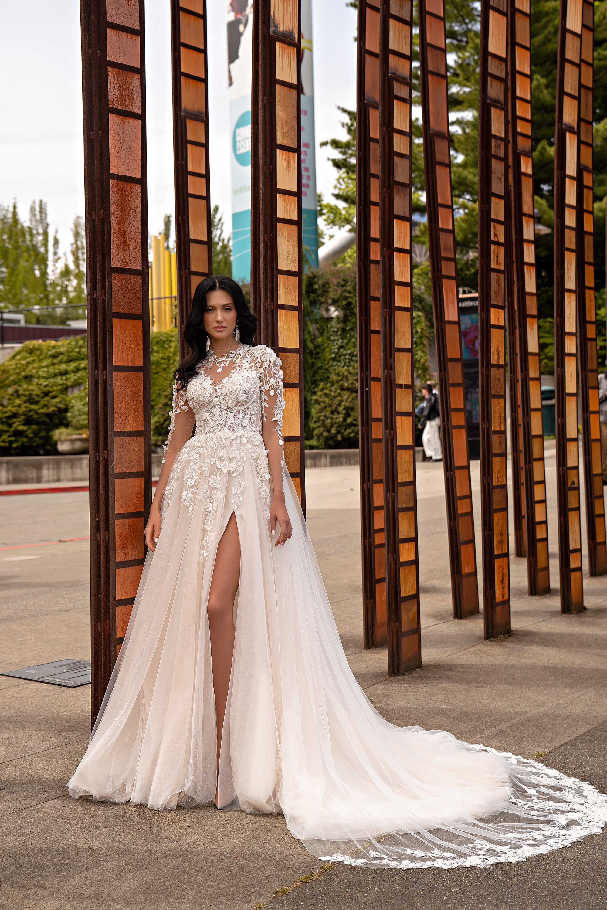 Ivory A-line wedding dress with floral lace sleeves, a thigh-high slit, and a long train