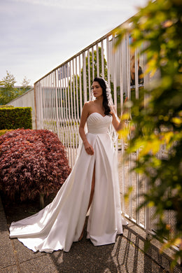 Ivory A-line wedding dress with a draped sweetheart neckline and high front slit