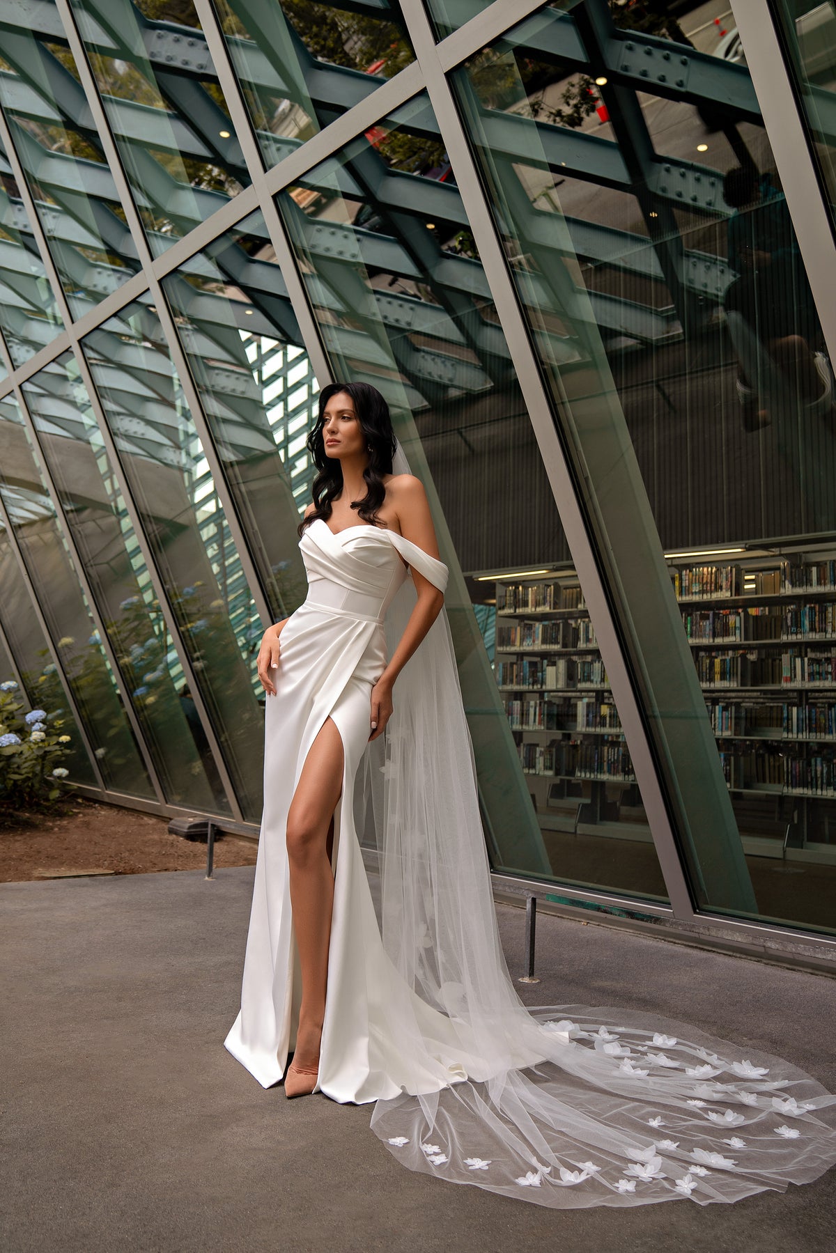 White off-the-shoulder wedding dress with ruched bodice, high thigh slit, and long floral-appliqué train
