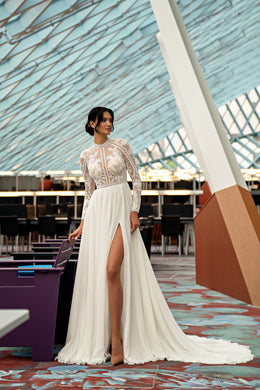 Ivory A-line wedding dress with a high lace neckline, long sleeves, thigh-high slit, and sweeping train