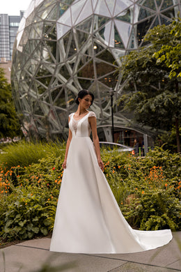 Ivory A-line wedding dress with beaded illusion V-neck, cap sleeves, and sweeping train