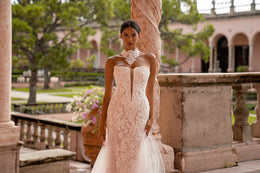 Close-up of an ivory wedding dress bodice with floral lace, strapless sweetheart neckline, and lace high-neck collar