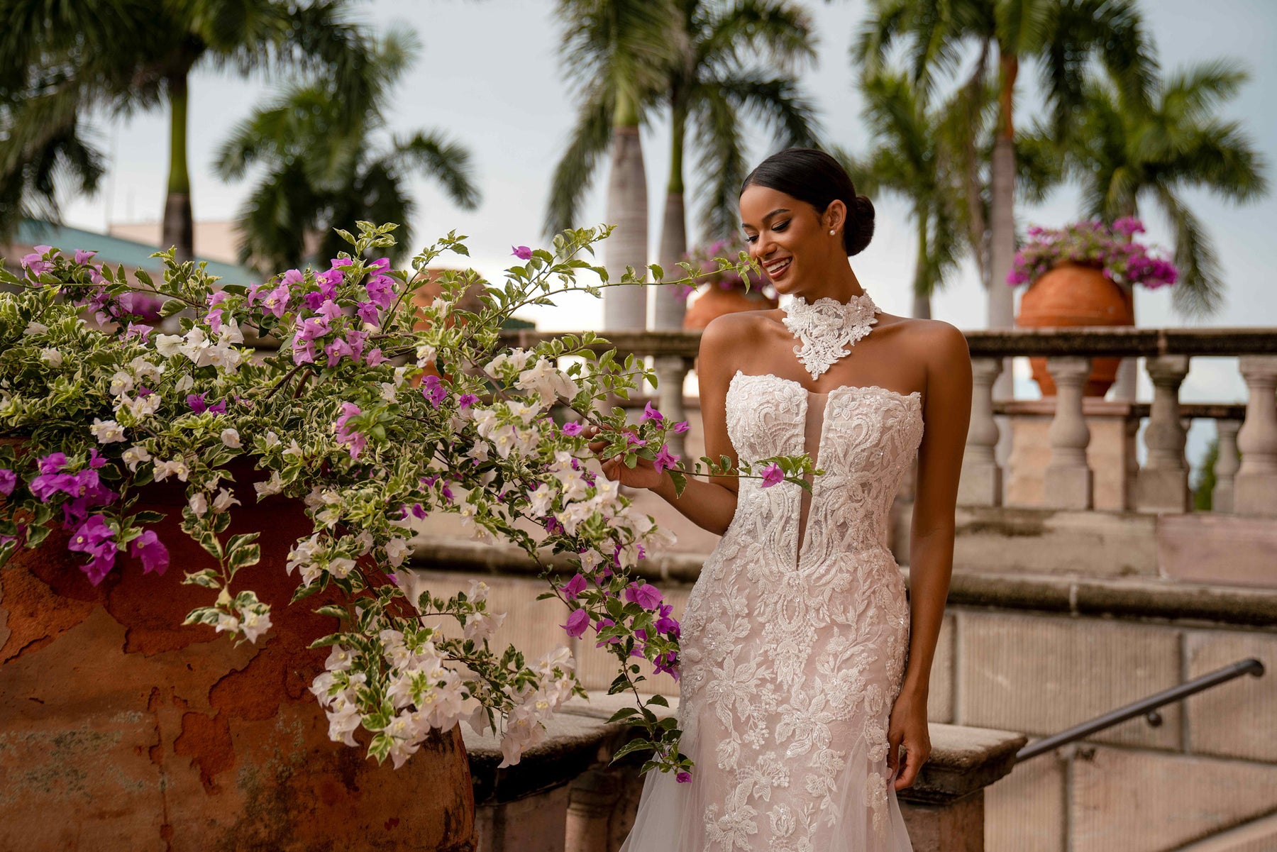 Fitted ivory mermaid wedding dress with floral lace, strapless neckline, and high-neck lace collar
