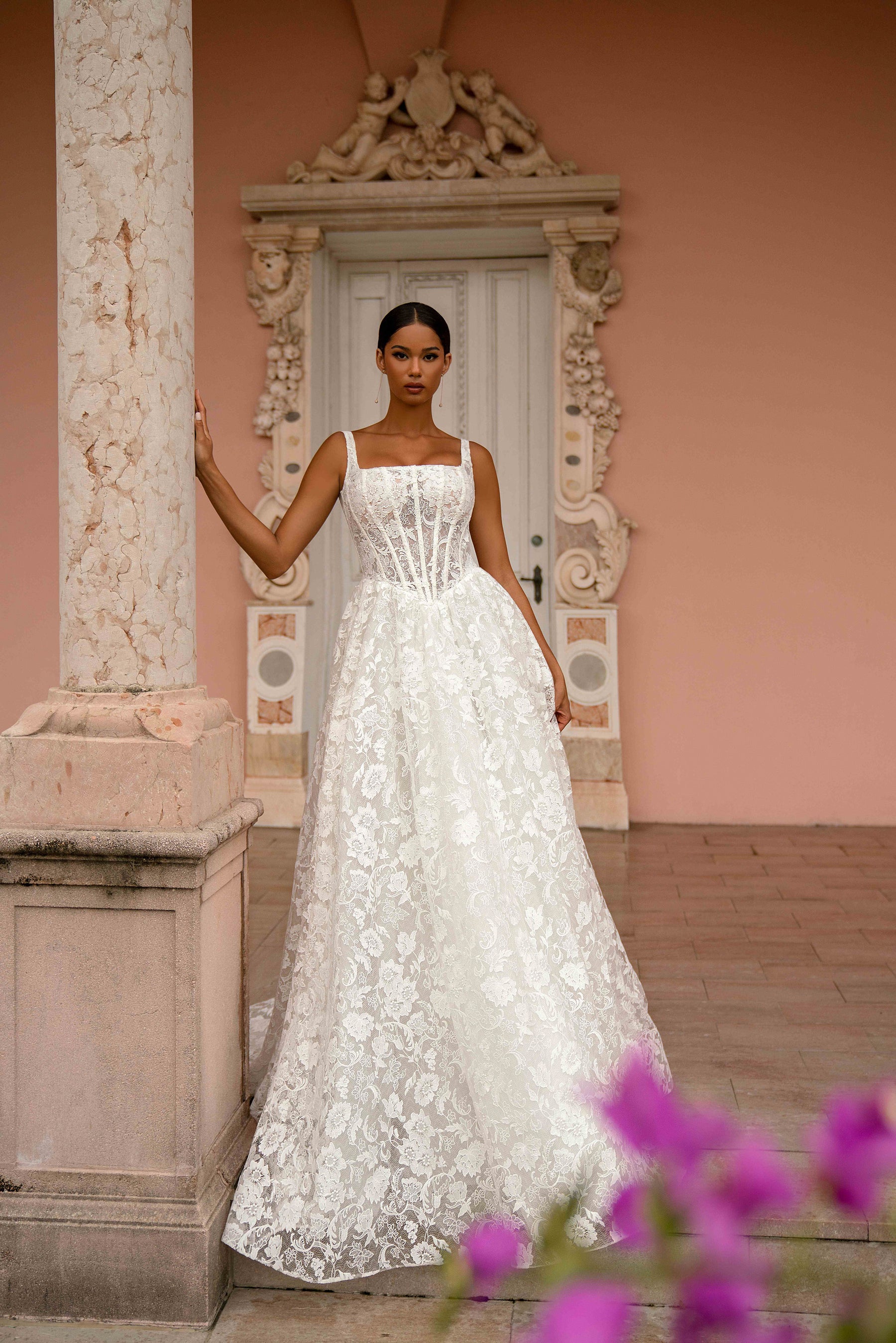 Floral lace ivory wedding dress featuring a square neckline, fitted bodice, thin straps, and an A-line skirt