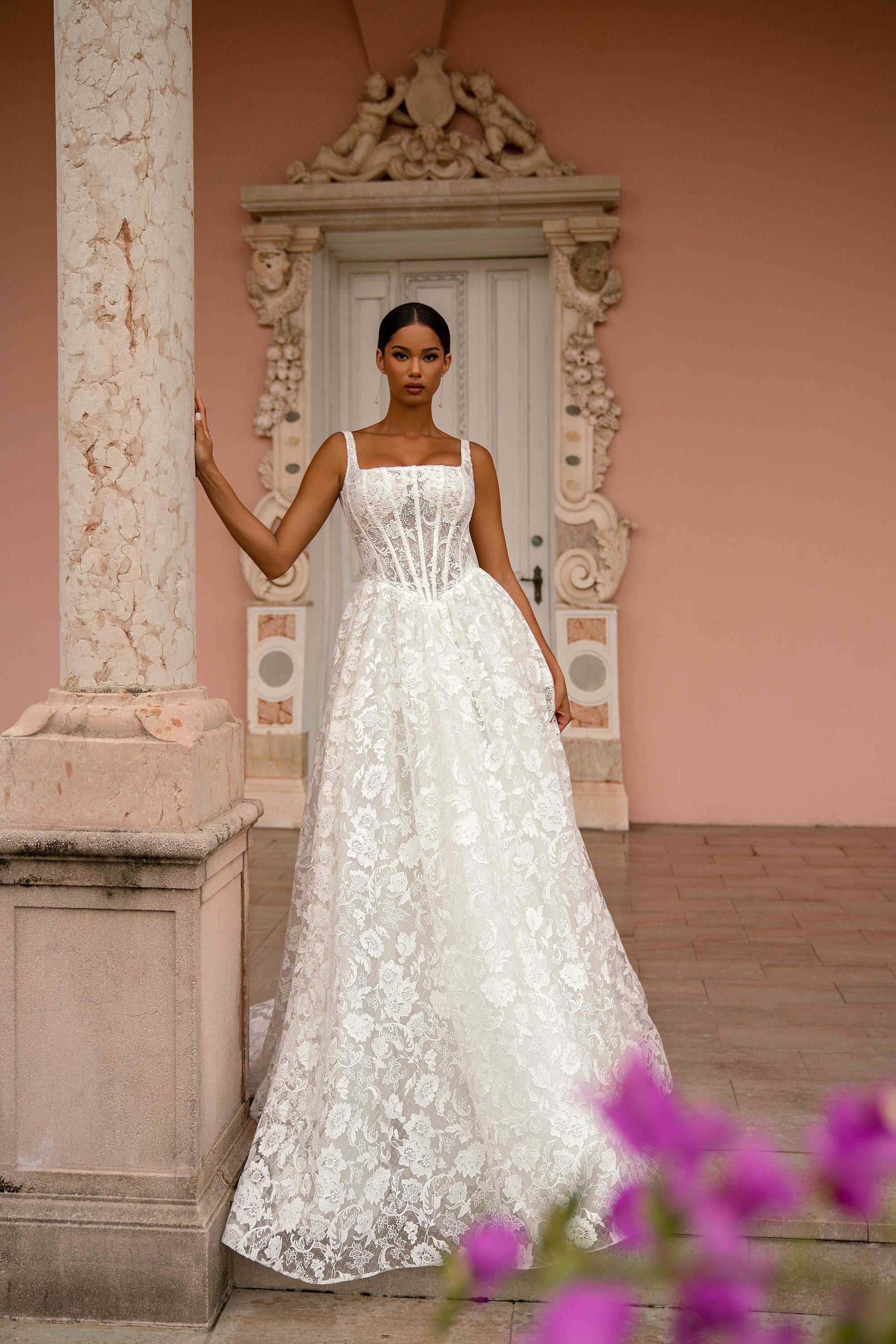 Floral lace ivory wedding dress featuring a square neckline, fitted bodice, thin straps, and an A-line skirt