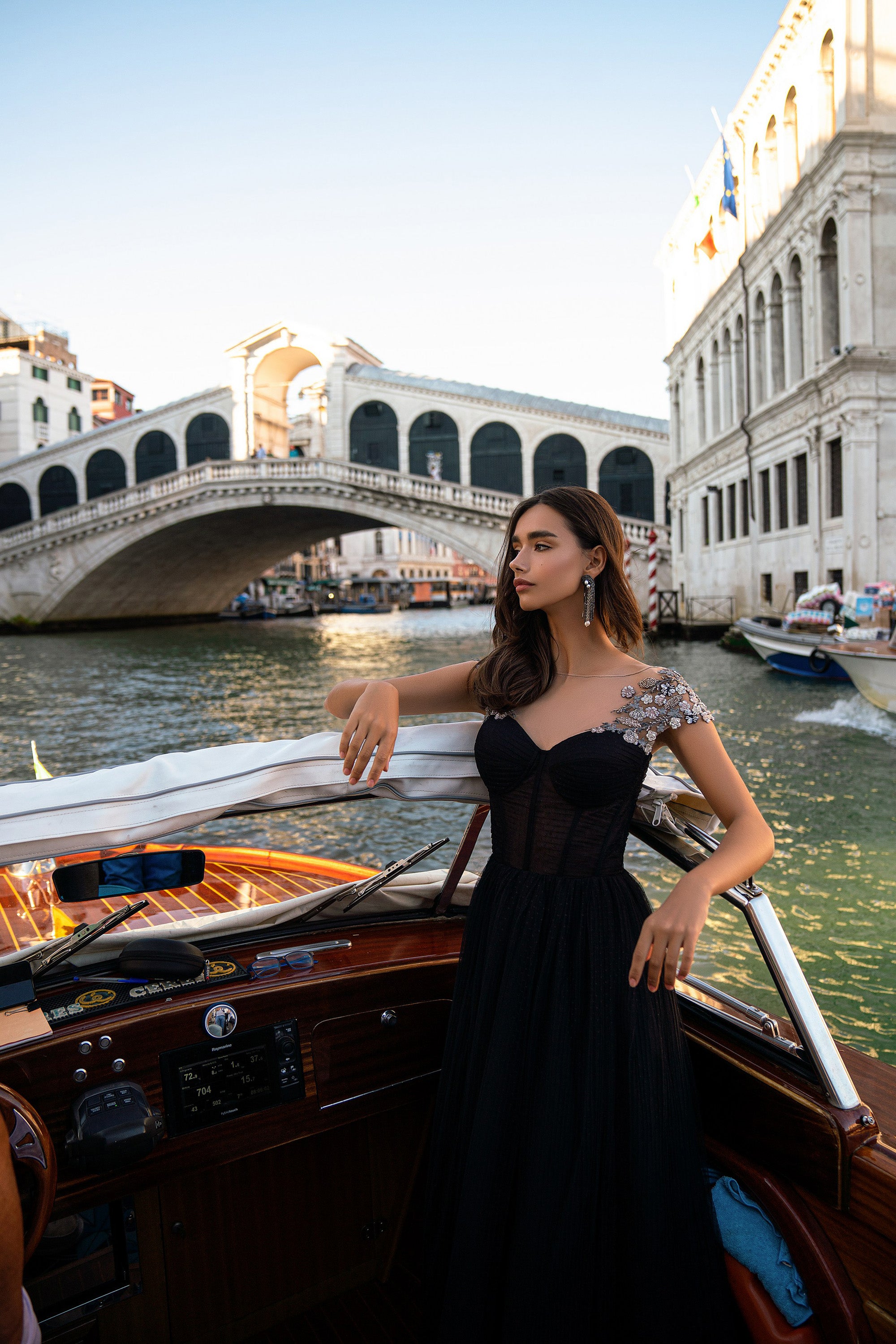 Sweetheart-neckline black evening dress with ornate silver shoulder embellishments and a full skirt