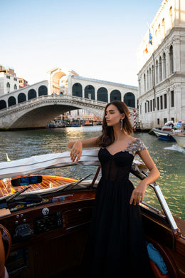 Sweetheart-neckline black evening dress with ornate silver shoulder embellishments and a full skirt