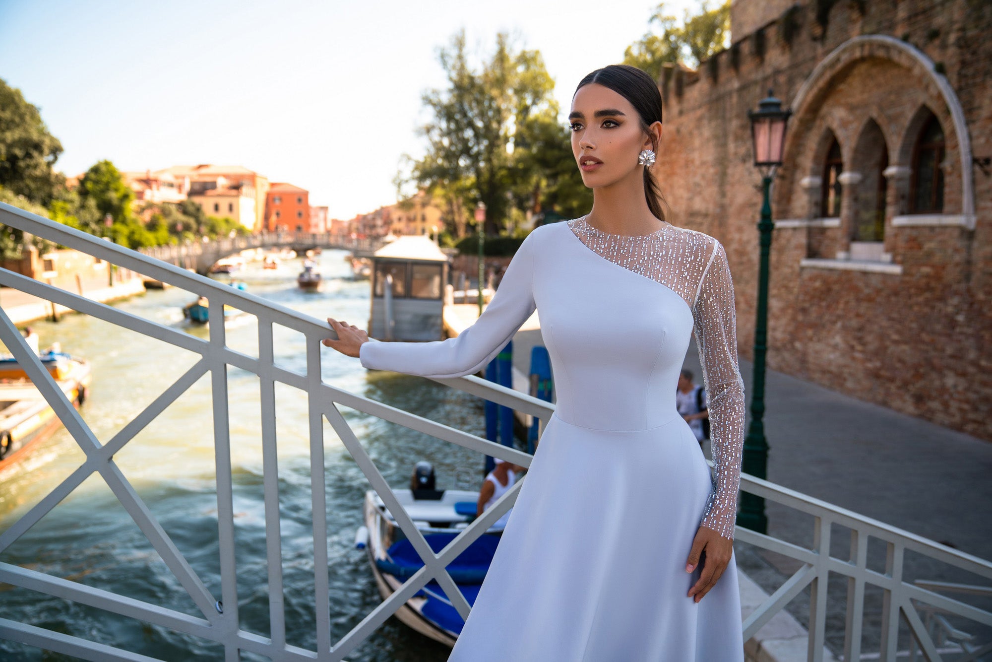Fitted pale lavender evening dress with a sheer embellished neckline, long sleeves, and a gently flared skirt