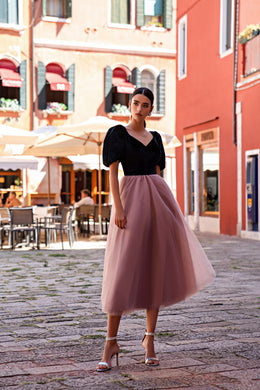 Black V-neck evening dress with puff sleeves and a full dusty-rose tulle midi skirt