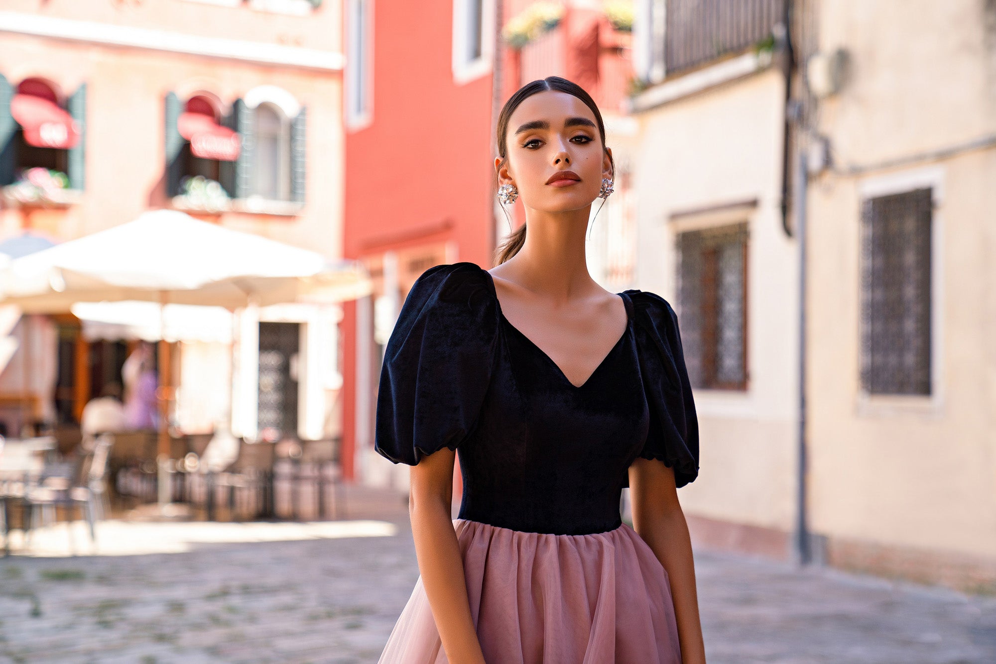 Close-up of the black V-neck bodice and puff sleeves on a dusty-rose evening dress