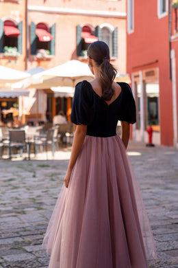 V-shaped back and gathered mauve tulle skirt on a black evening dress with puff sleeves