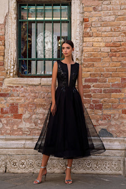 Black sleeveless evening dress with a sparkling V-neck bodice and flowing sheer-overlay skirt